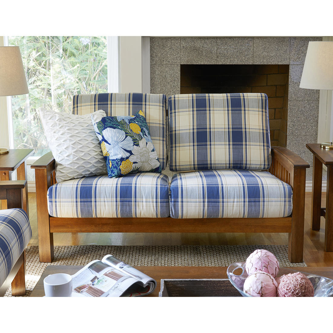 a plaid upholstered and wooden framed loveseat