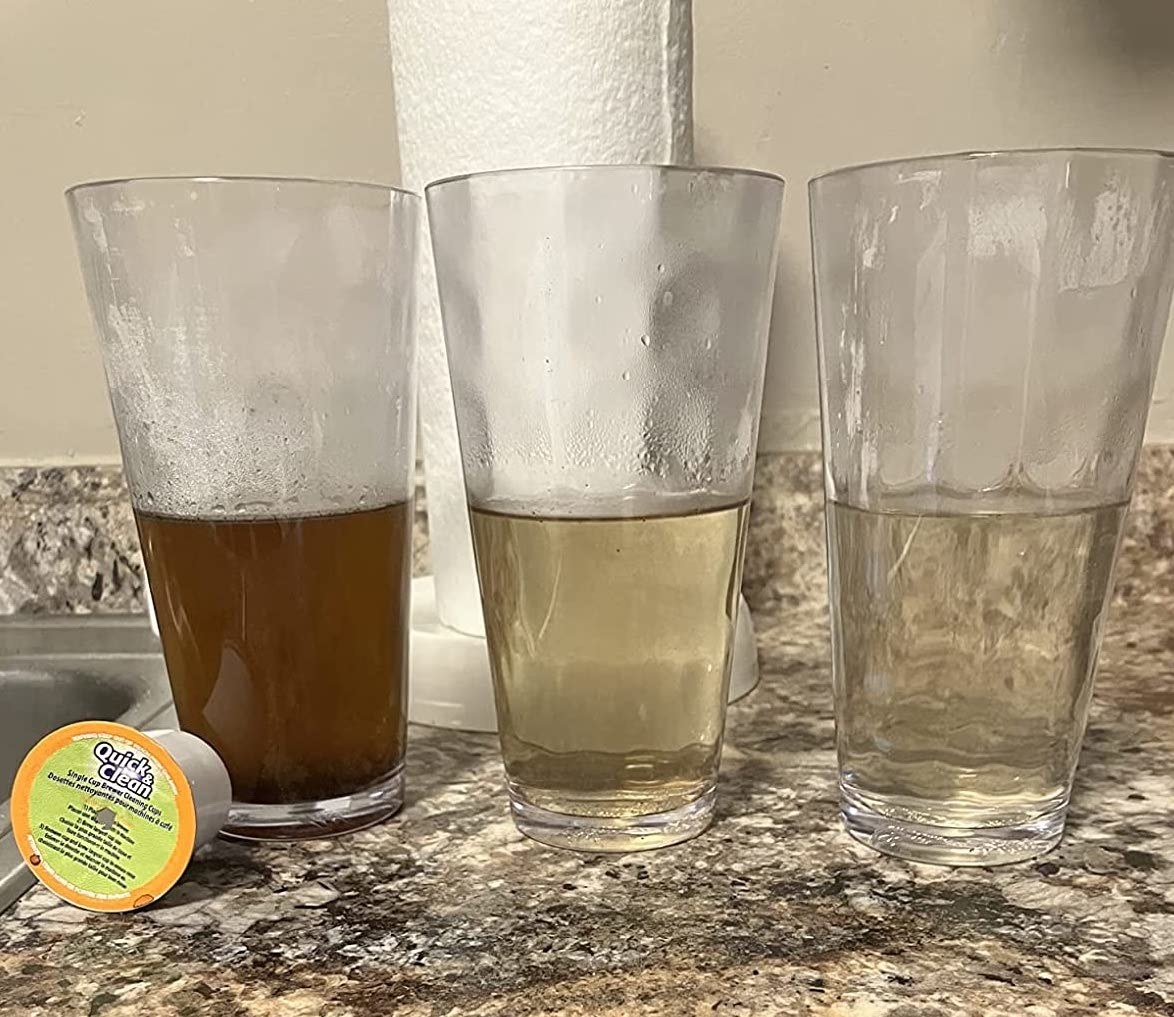 three glasses of water going from dirty to clean after using the k-cup cleaner