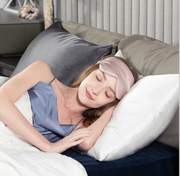 model sleeping on a satin pillowcase