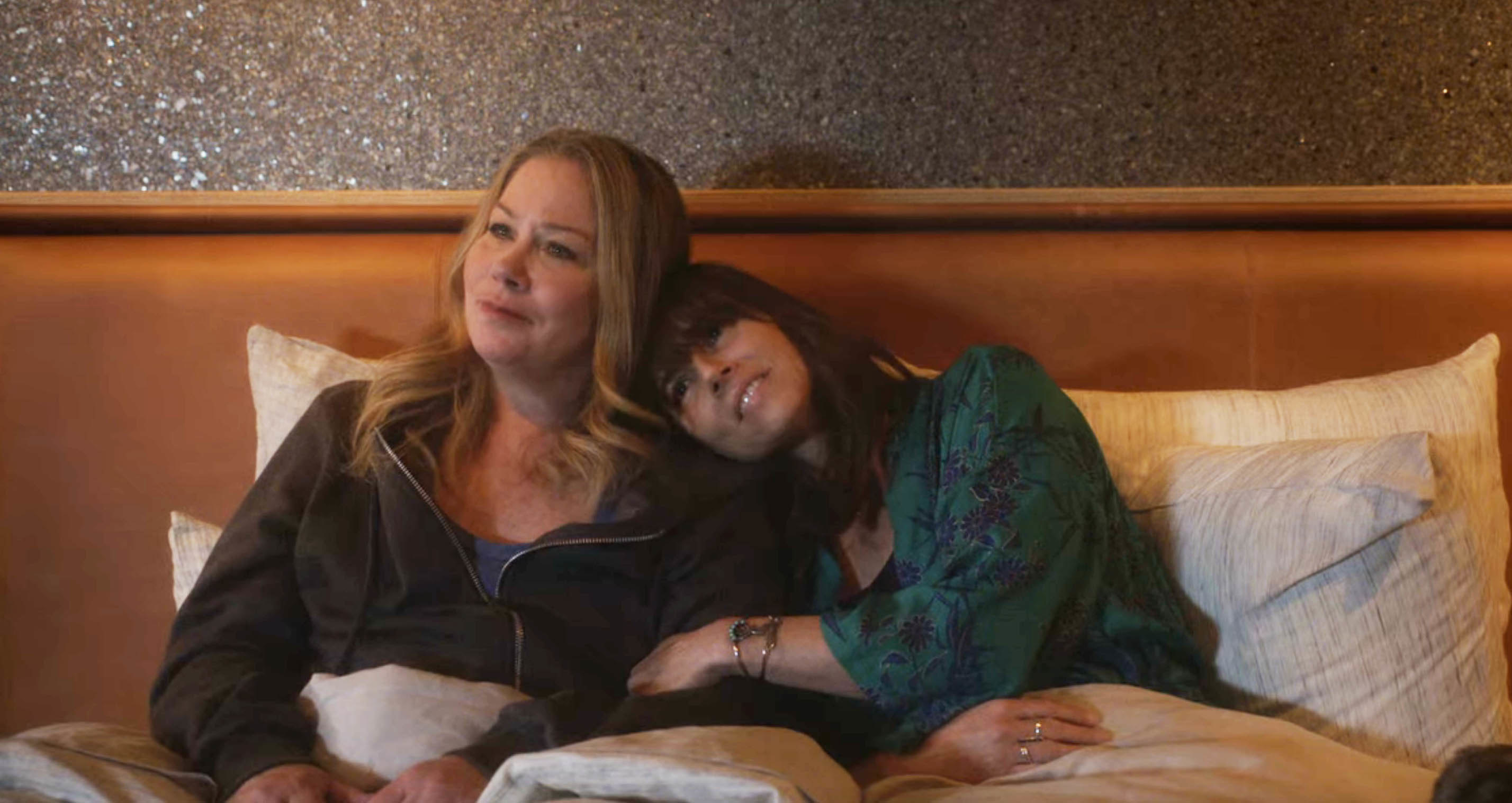 Jen and Judy sitting up in bed together