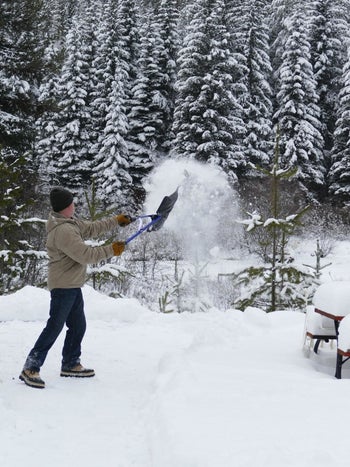 A reviewer using the shovel to shovel snow
