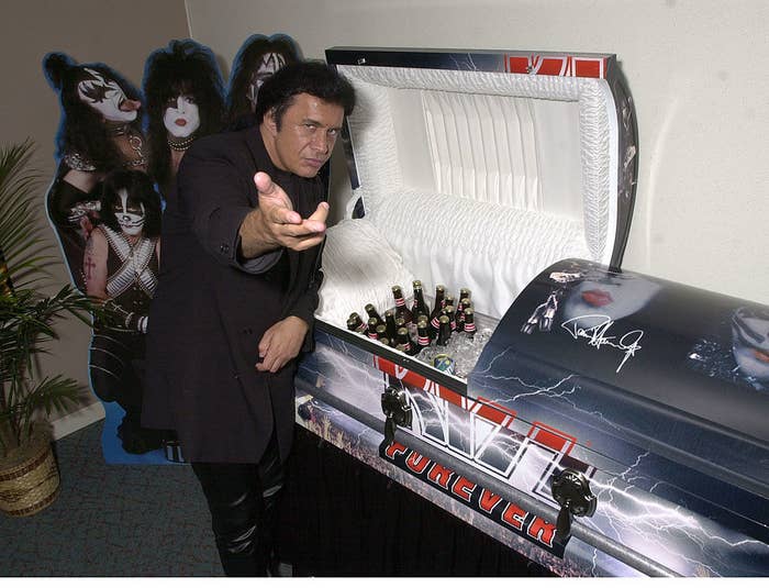 gene simmons posing by the casket being used as a cooler full of beer