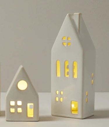 the two houses lit up against a plain background