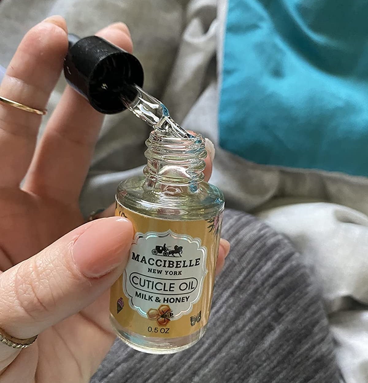 Reviewer holding bottle of cuticle oil