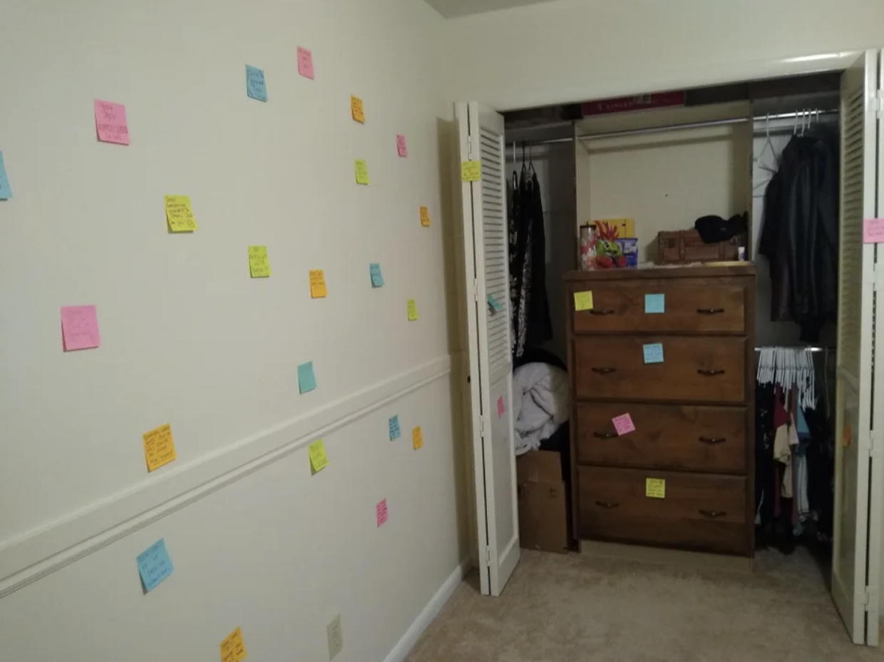 post its covering the walls of a bedroom