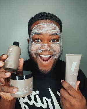 A man using the products and holding them