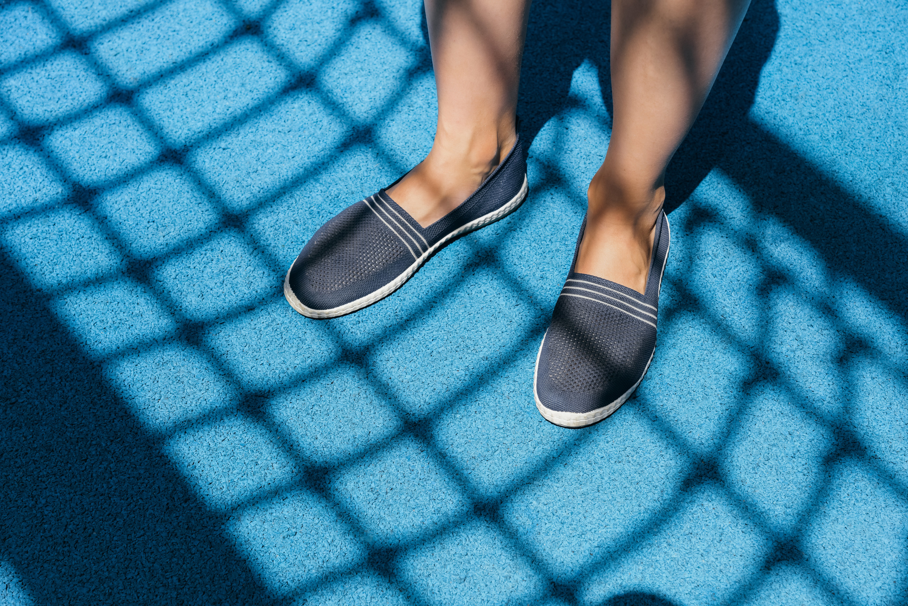 Pair of slip-on shoes on blue carpeting
