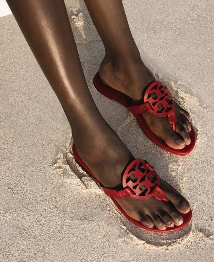 A person wearing the sandals on a beach
