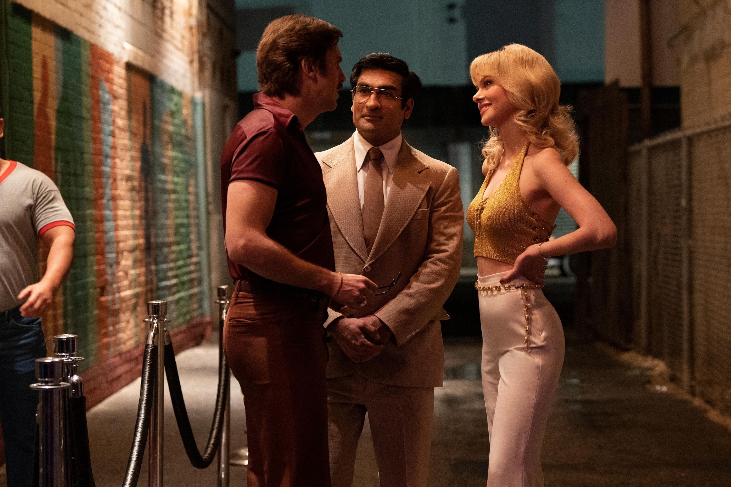 Banerjee and Snider talking to a woman outside of a club in a scene from the miniseries