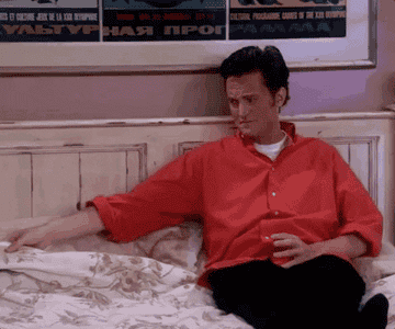 Chandler Bing offering a seat next to him in bed