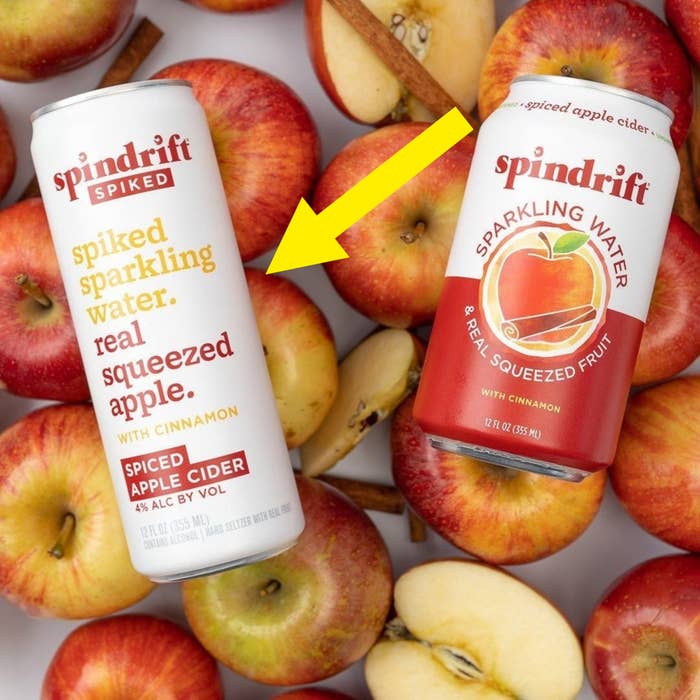 Spindrift Spike Apple Ciders on top of apples and cinnamon sticks