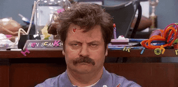 Gif of Nick Offerman as Ron Swanson in &quot;Parks and Recreation&quot; looking very annoyed in an extremely messy office as two children make more mess
