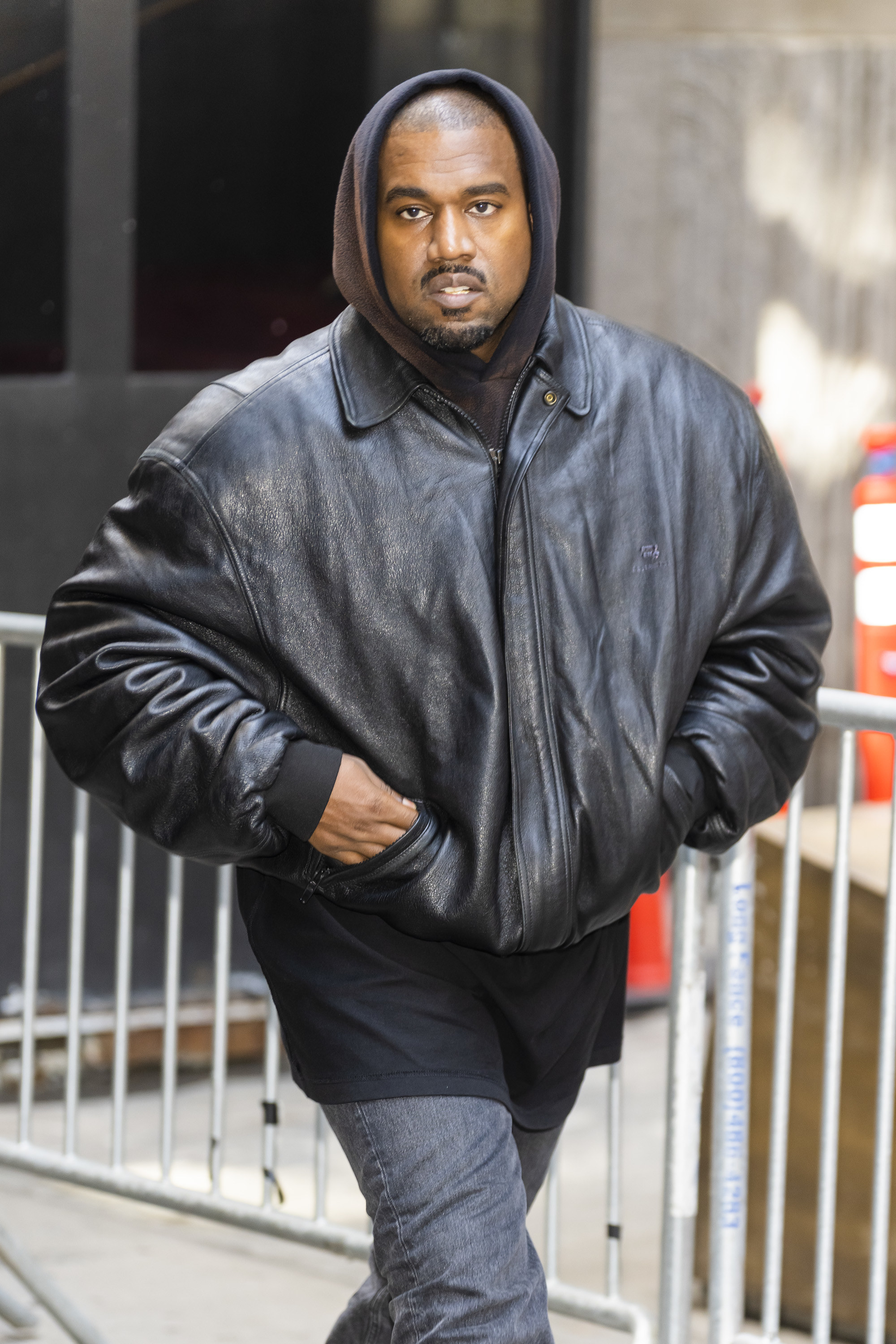 Ye in a leather jacket and jeans
