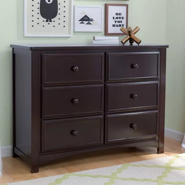The six-drawer dresser with a few items on top