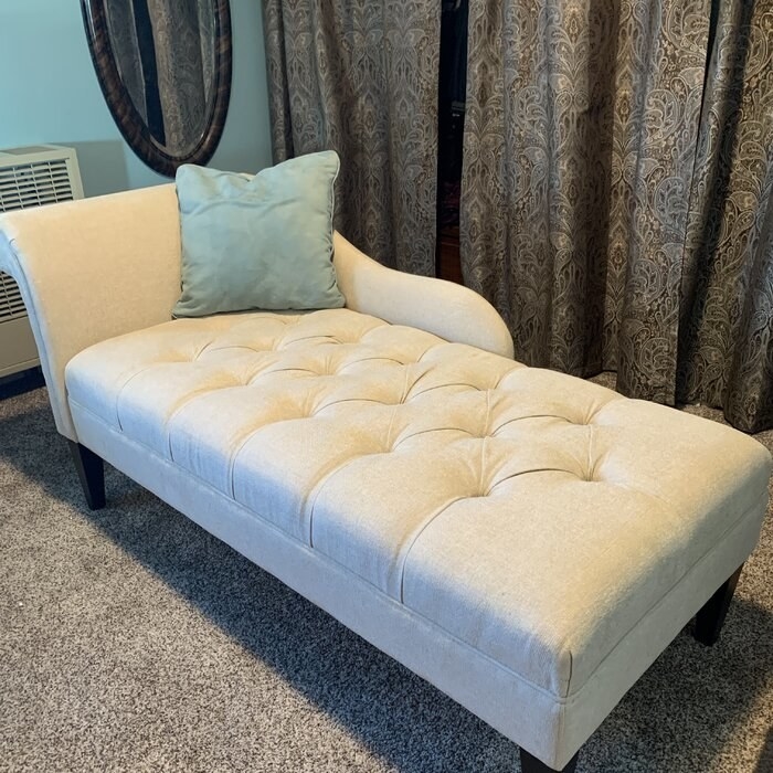 reviewer&#x27;s white tufted chaise lounge with the back on its right side