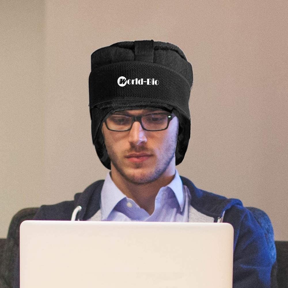 person sitting on their computer with the beanie on their head