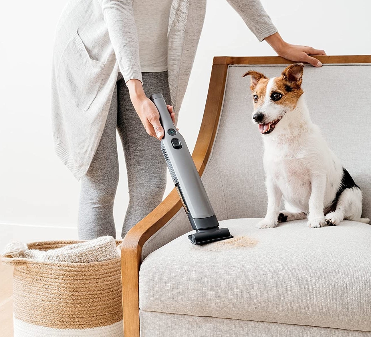 someone using the shark vacuum to clean up pet hair from their couch