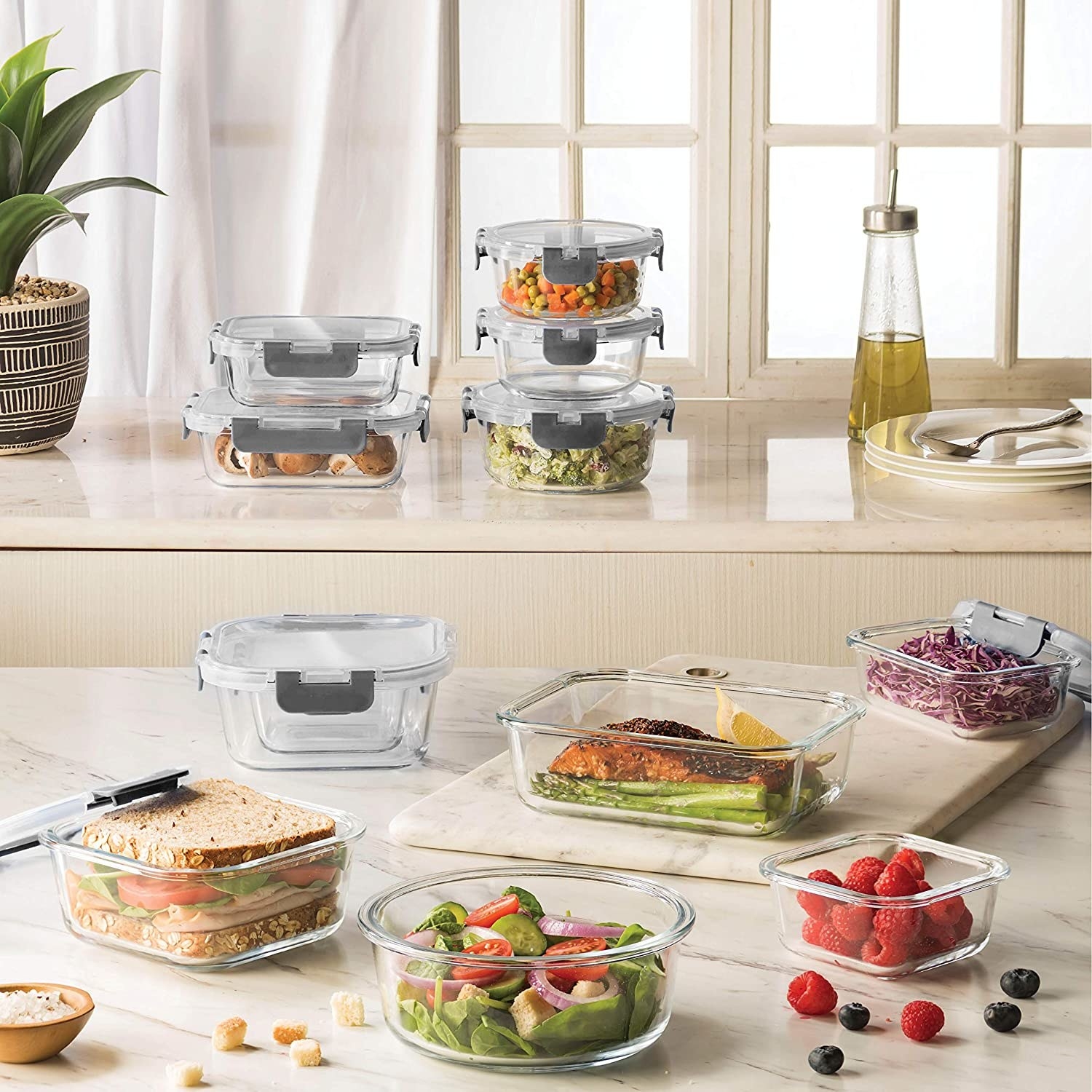 a set of glass food storage containers on a kitchen counter