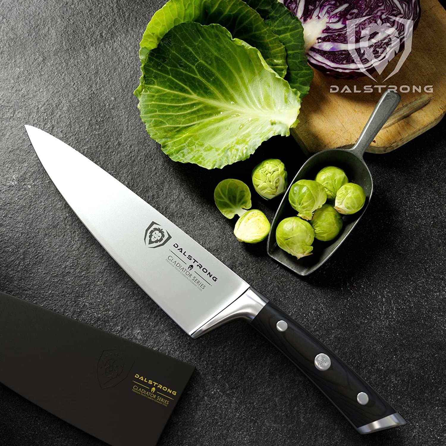a chef knife on a granite counter next to veggies
