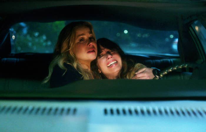 Jen holding onto a tearful Judy as they sit in a car