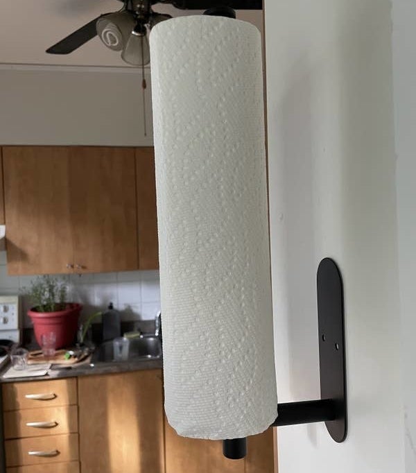 a paper towel roll on a paper towel holder stuck to a wall