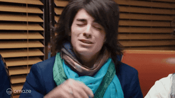 a gif of a Joe Jonas snapping his fingers excitedly