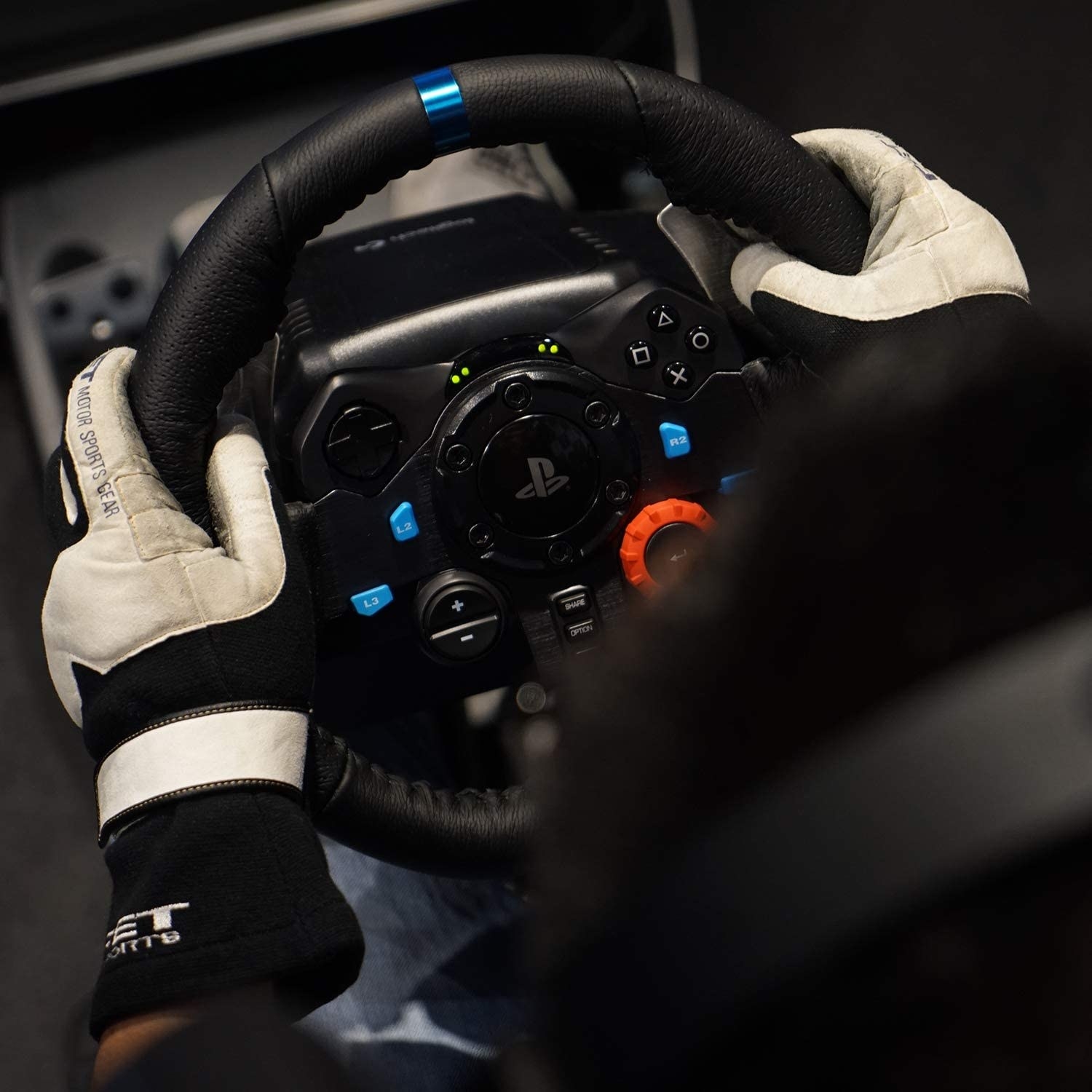 A person using the racing wheel while gaming