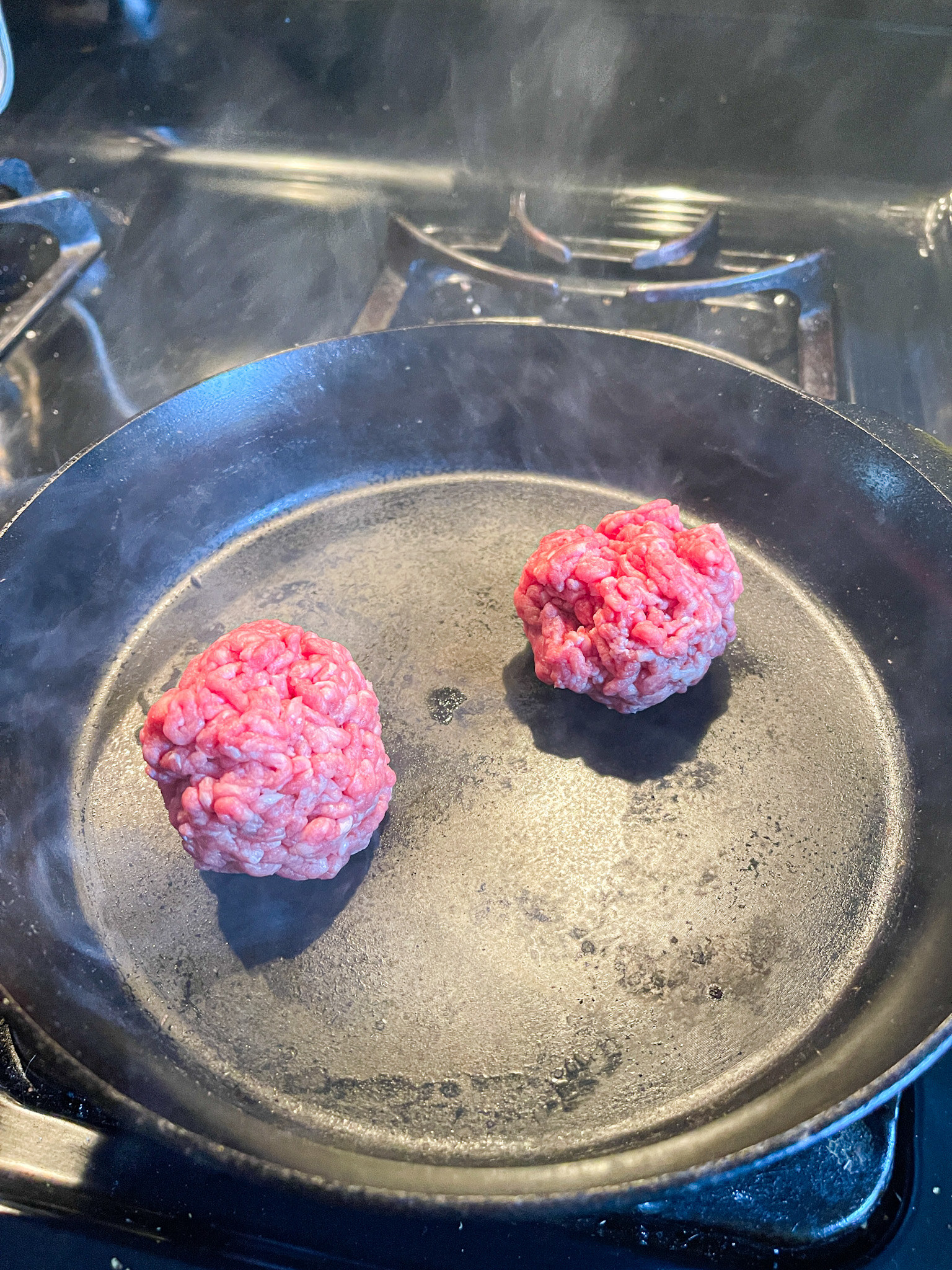 smoky skillet with burger balls on it