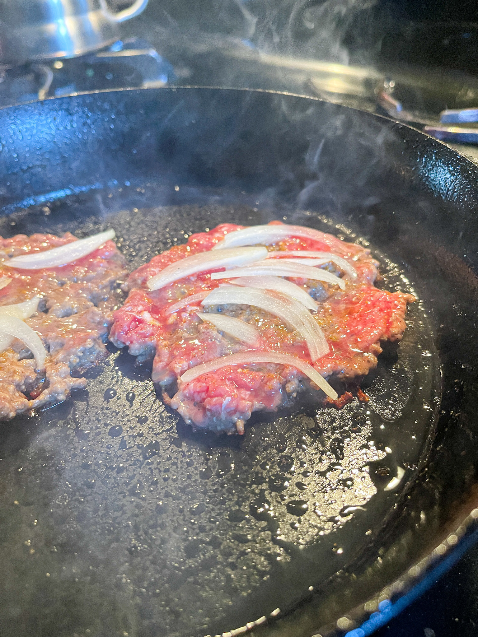 shaved onions on top of burger