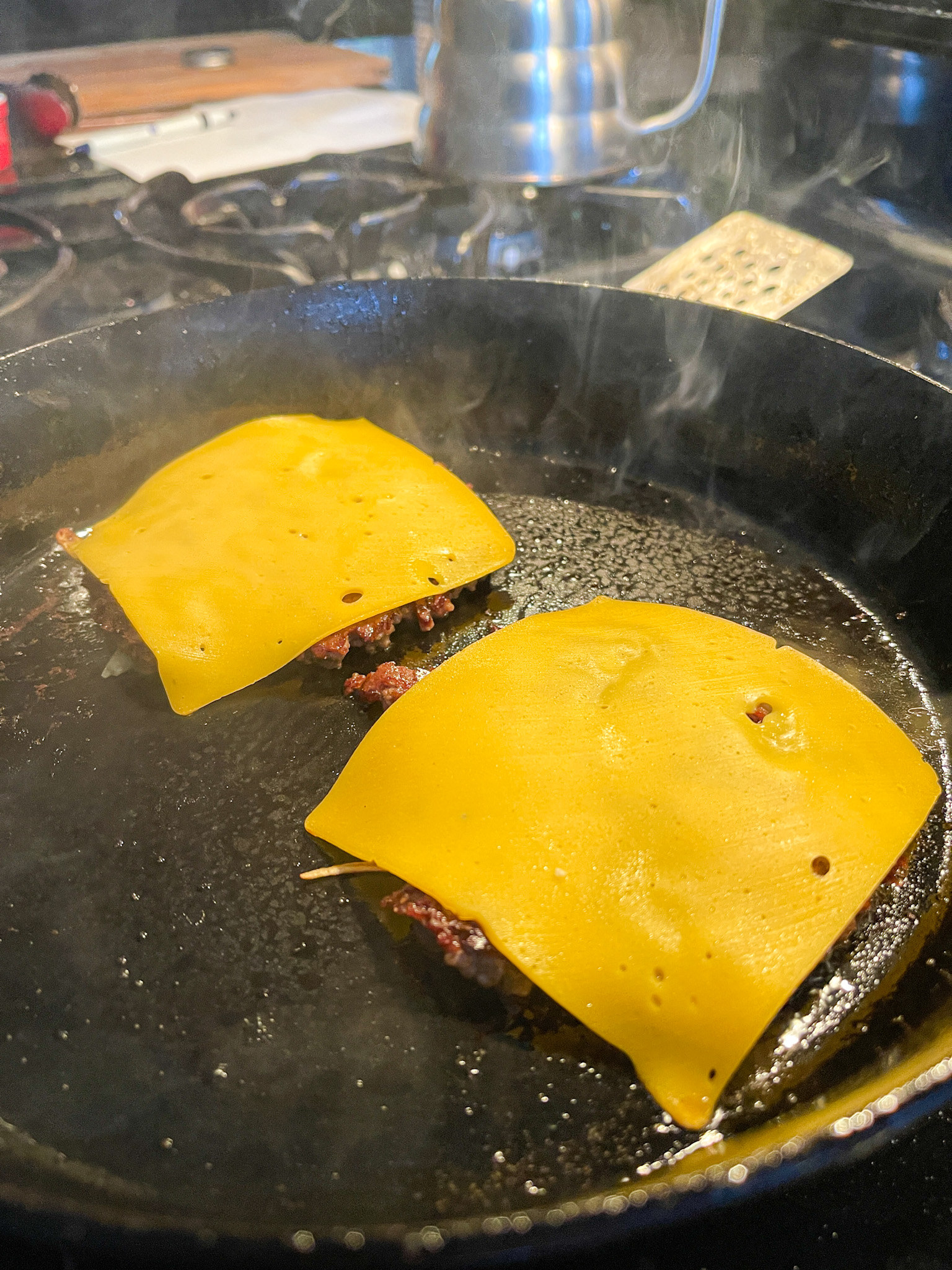 american cheese placed on top of burger