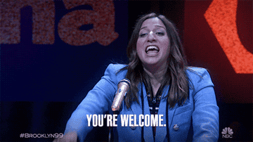 Chelsea Peretti saying you&#x27;re welcome at a mic stand and pointing