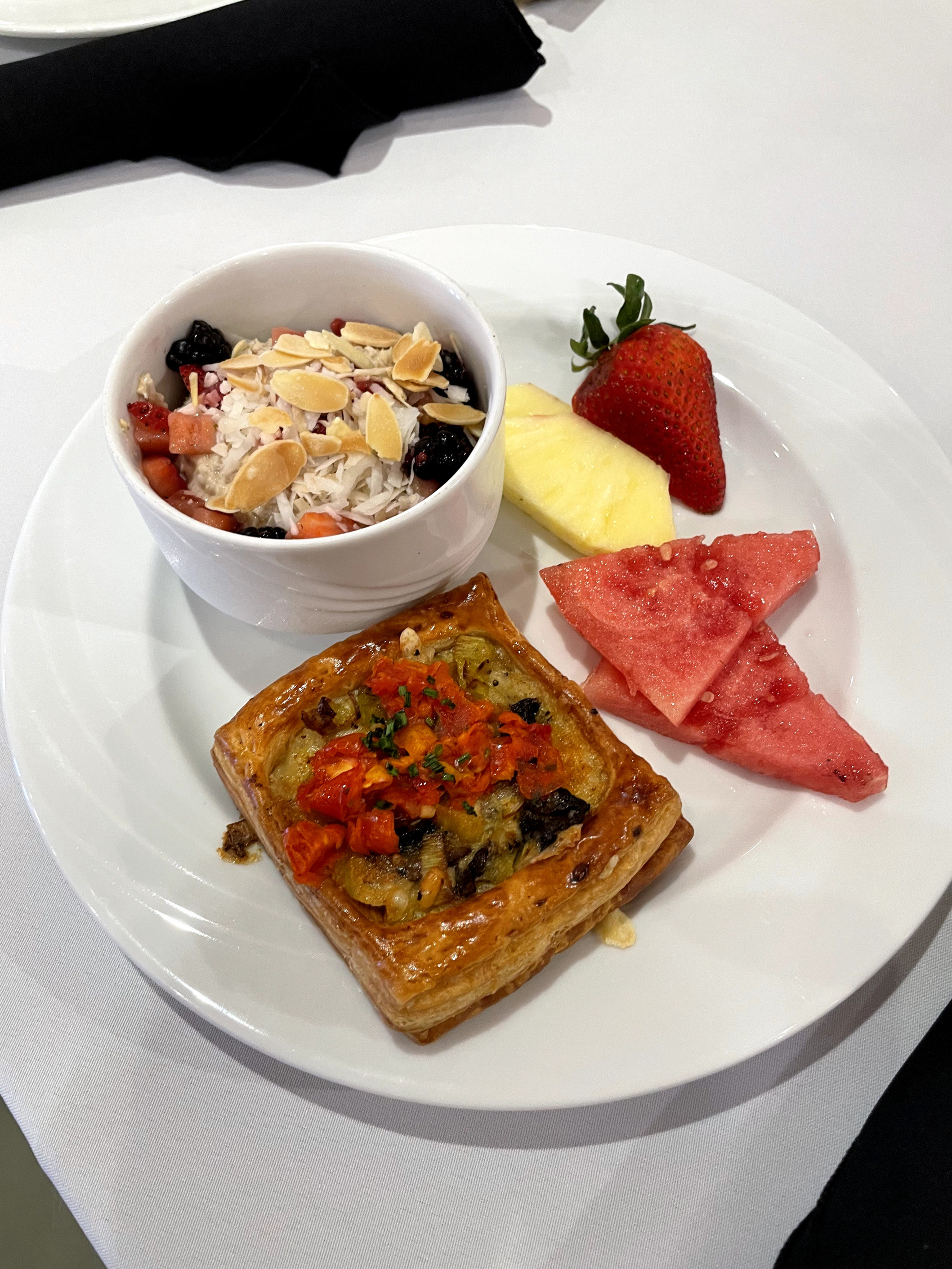 A photo of fruits and a cooked breakfast