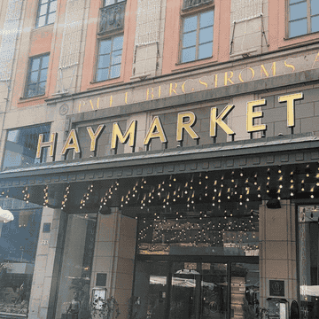 Front of Haymarket hotel with flag hanging from the walls