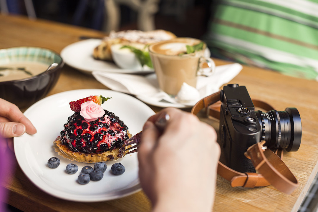 Swedish tart, camera and coffee cup on a table