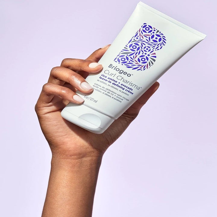 model holding the Curl Charisma leave-in defining crème