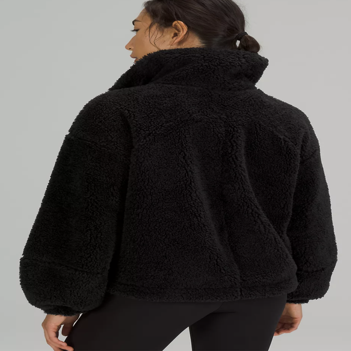 A person showing off the back of the jacket