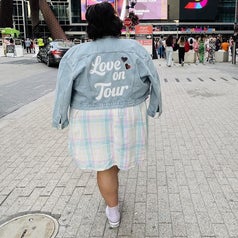 Bianca wearing a jacket she designed and made with her Cricut outside of an arena