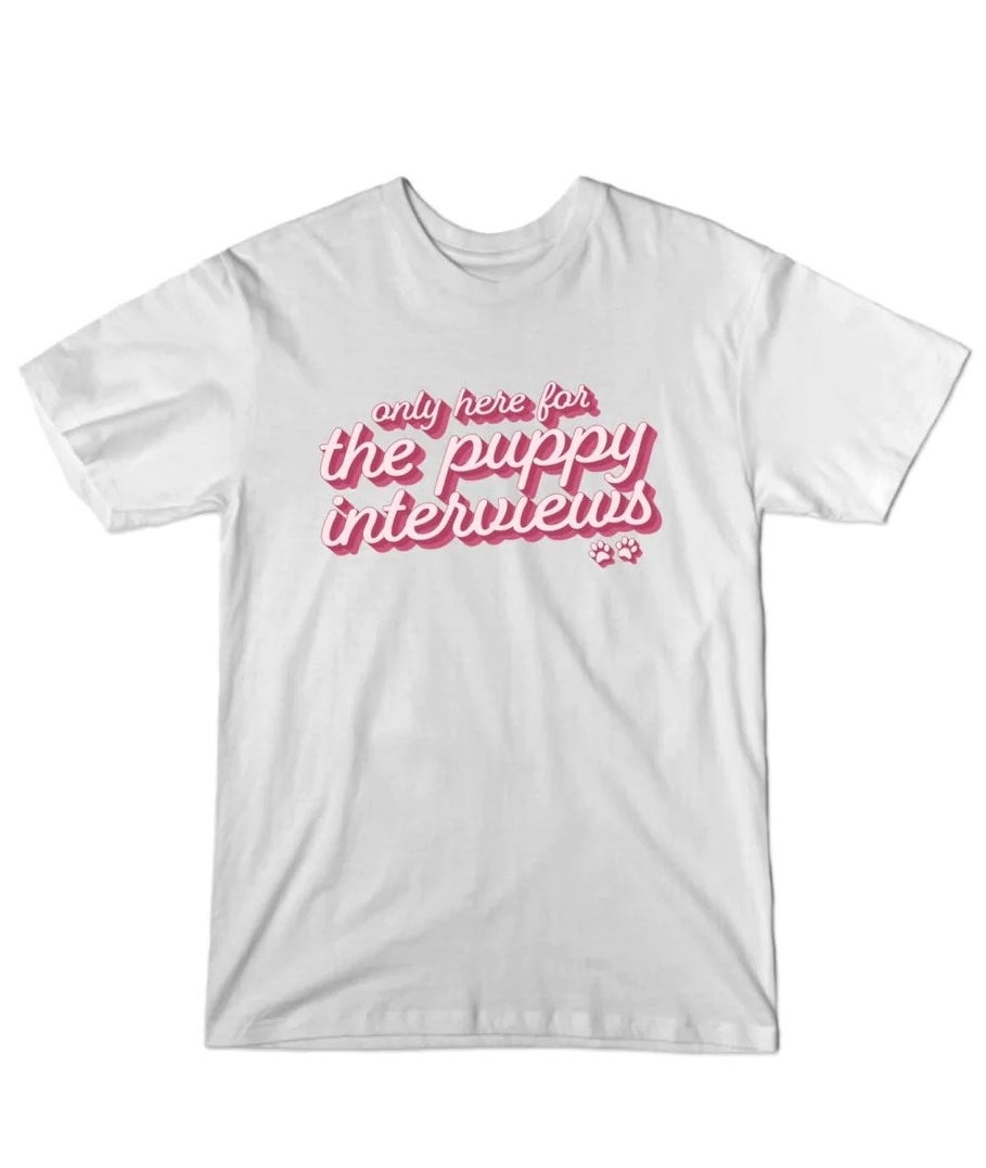 white t-shirt that says &quot;only here for the puppy interviews&quot; in pink cursive font