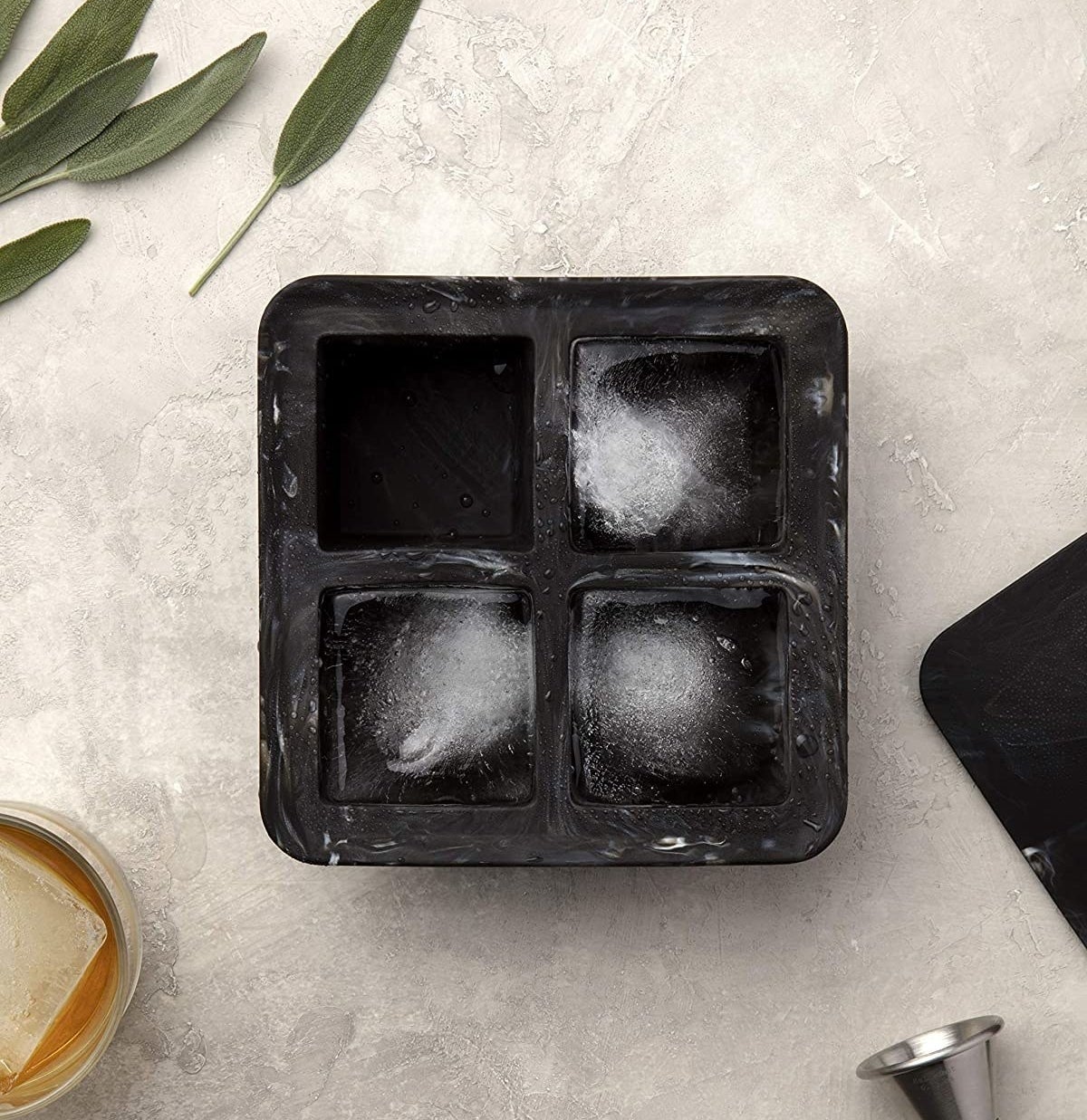 the ice cube tray with three ice cubes in it and one empty square