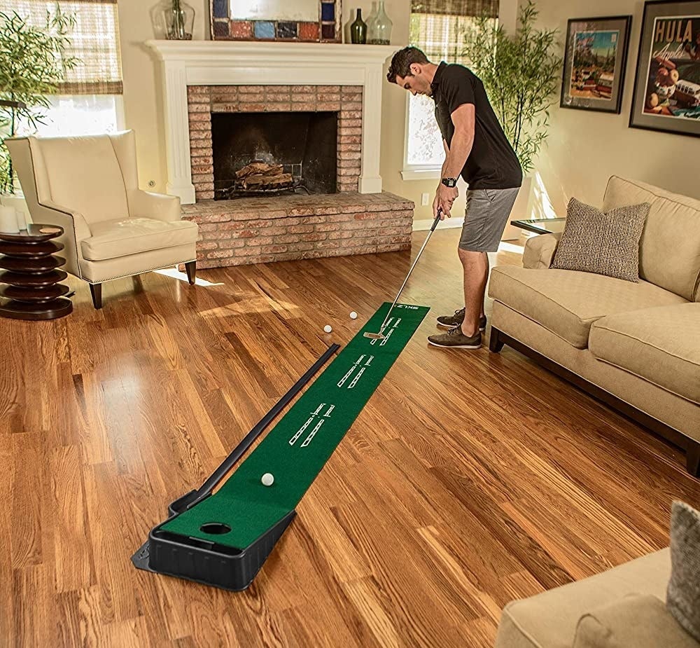 someone using the putting green in a living room