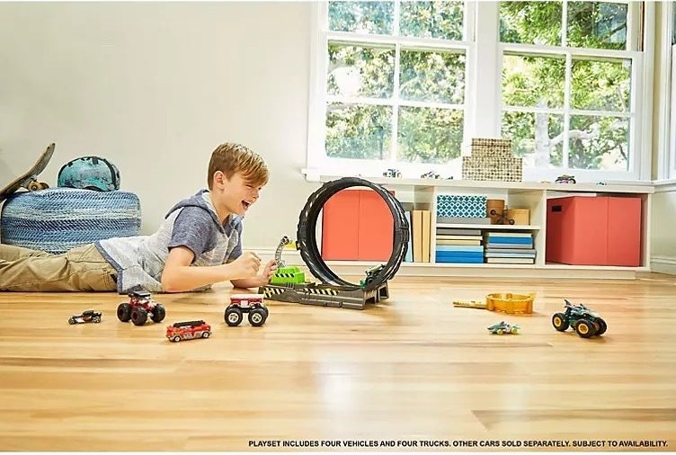 A child playing with the Hot Wheel set