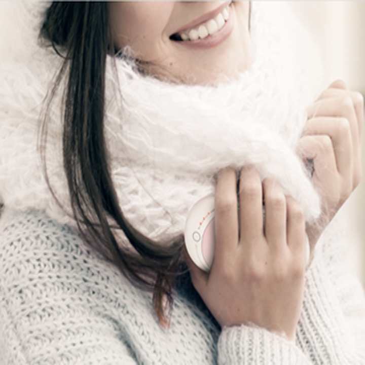 A model with a pink warmer in their hand