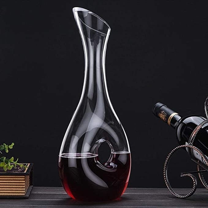 A picture of a red wine decanter and a wine bottle