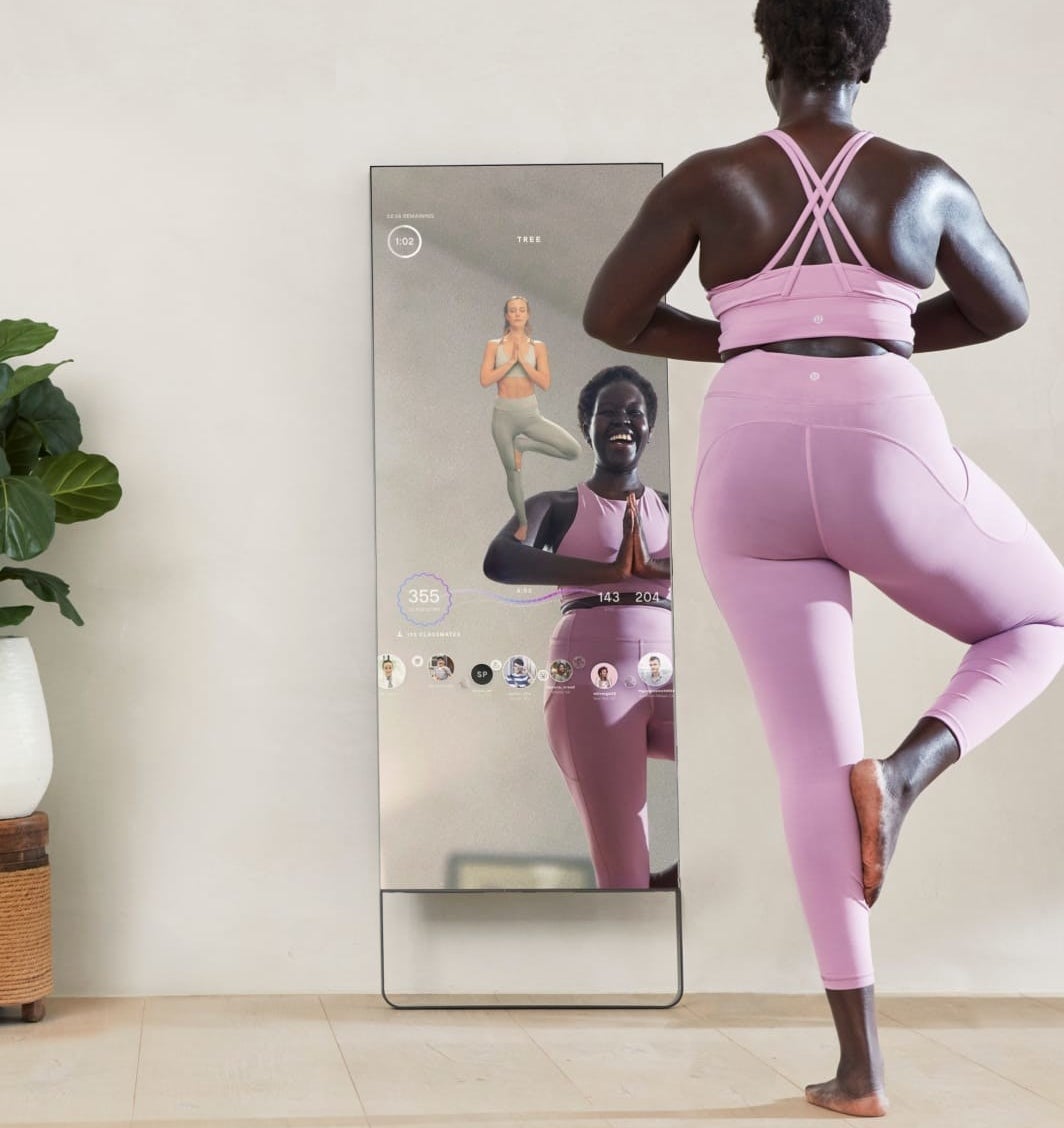 A person doing yoga in front of the mirror