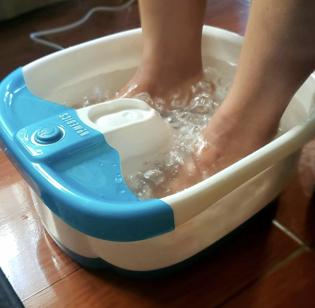 Reviewer&#x27;s feet in a bubbling foot basin