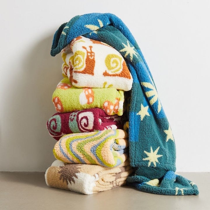 A stack of folded patterned blankets
