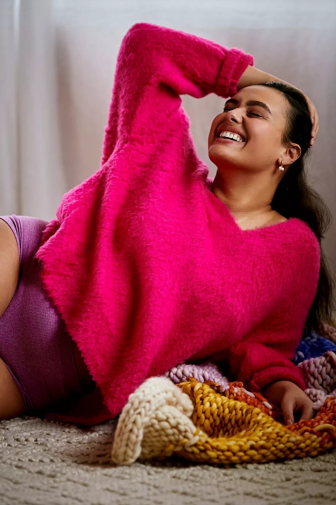 model wearing fluffy v-neck pink sweater
