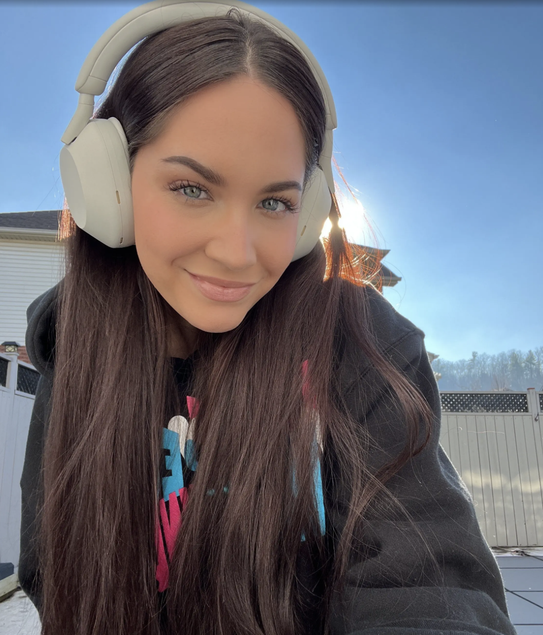 a photo of Melina wearing the headphones outside