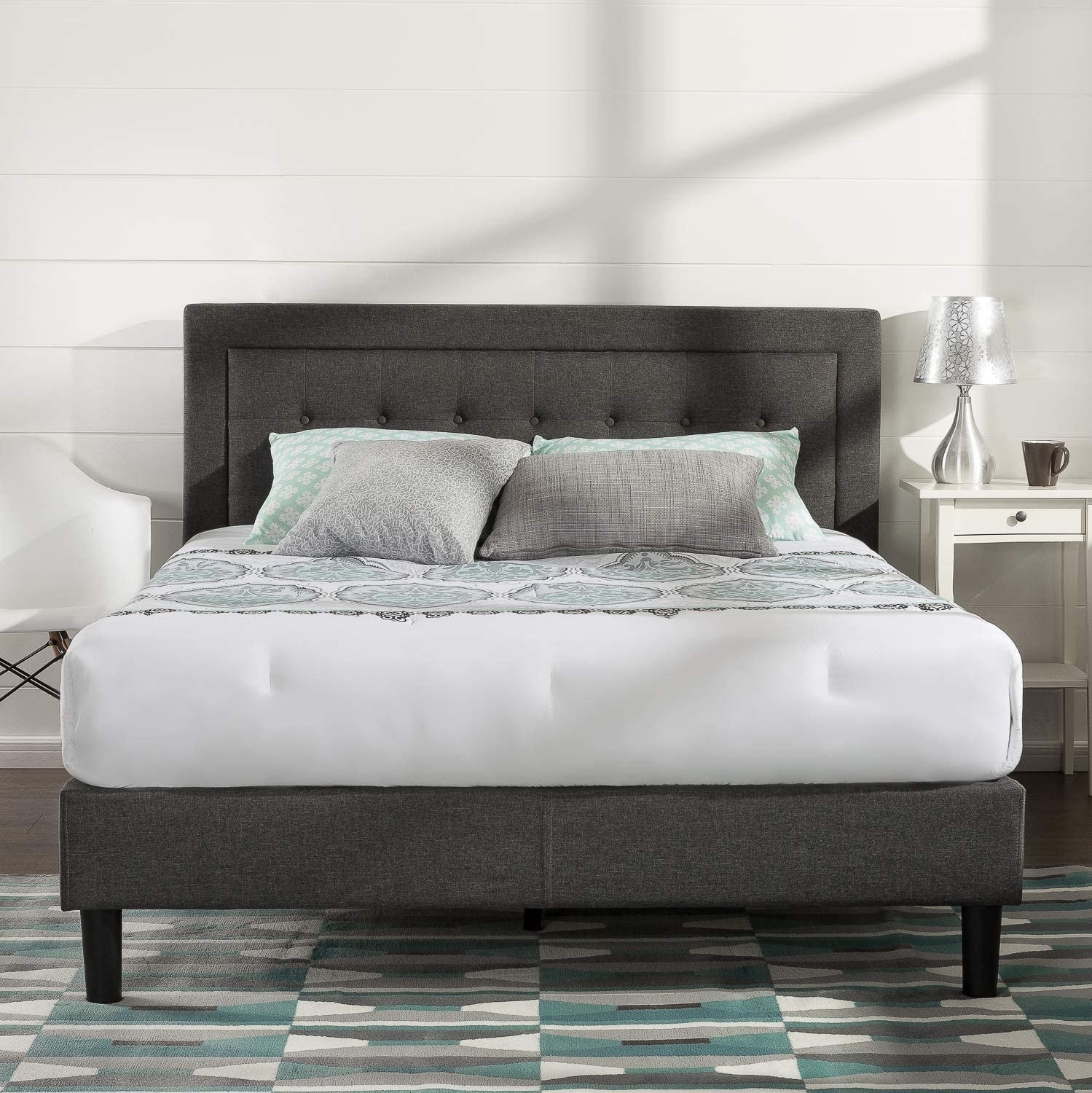 the tufted bed frame in a tidy and stylish bedroom