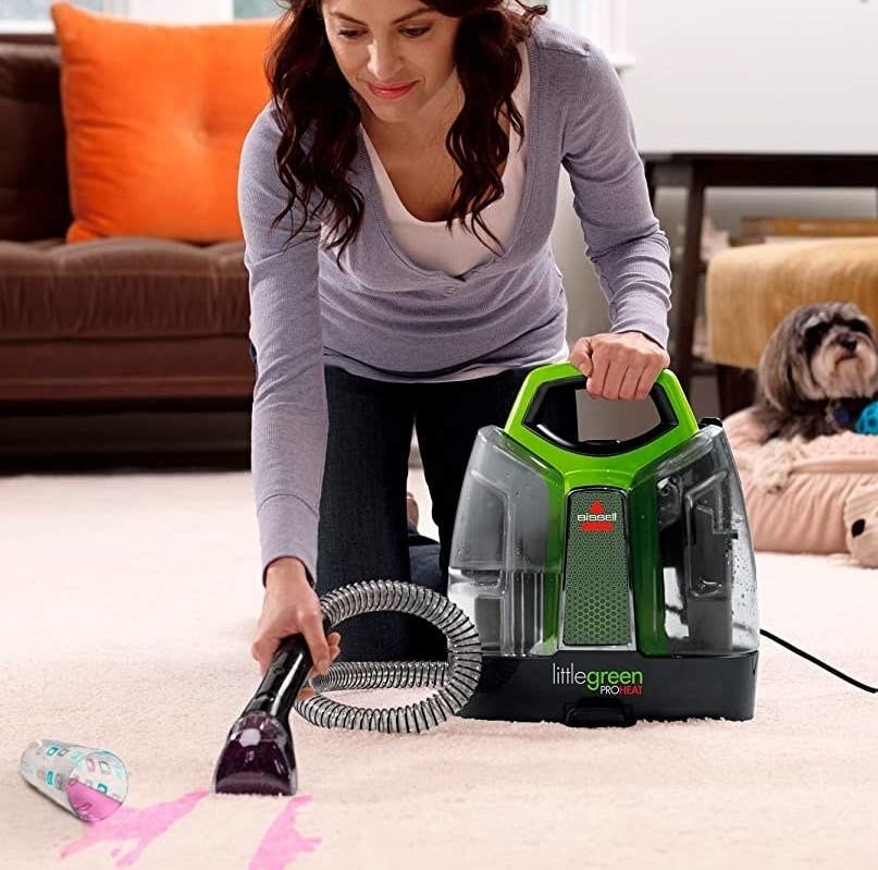 a person using a carpet cleaner
